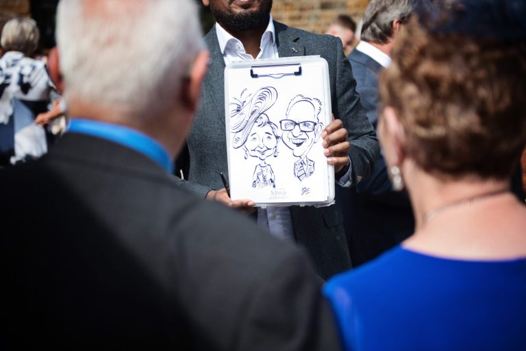 Caricaturist showing off his work to his clients.