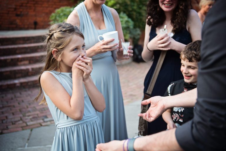 Flower girl gets wowed by the magician's magic trick