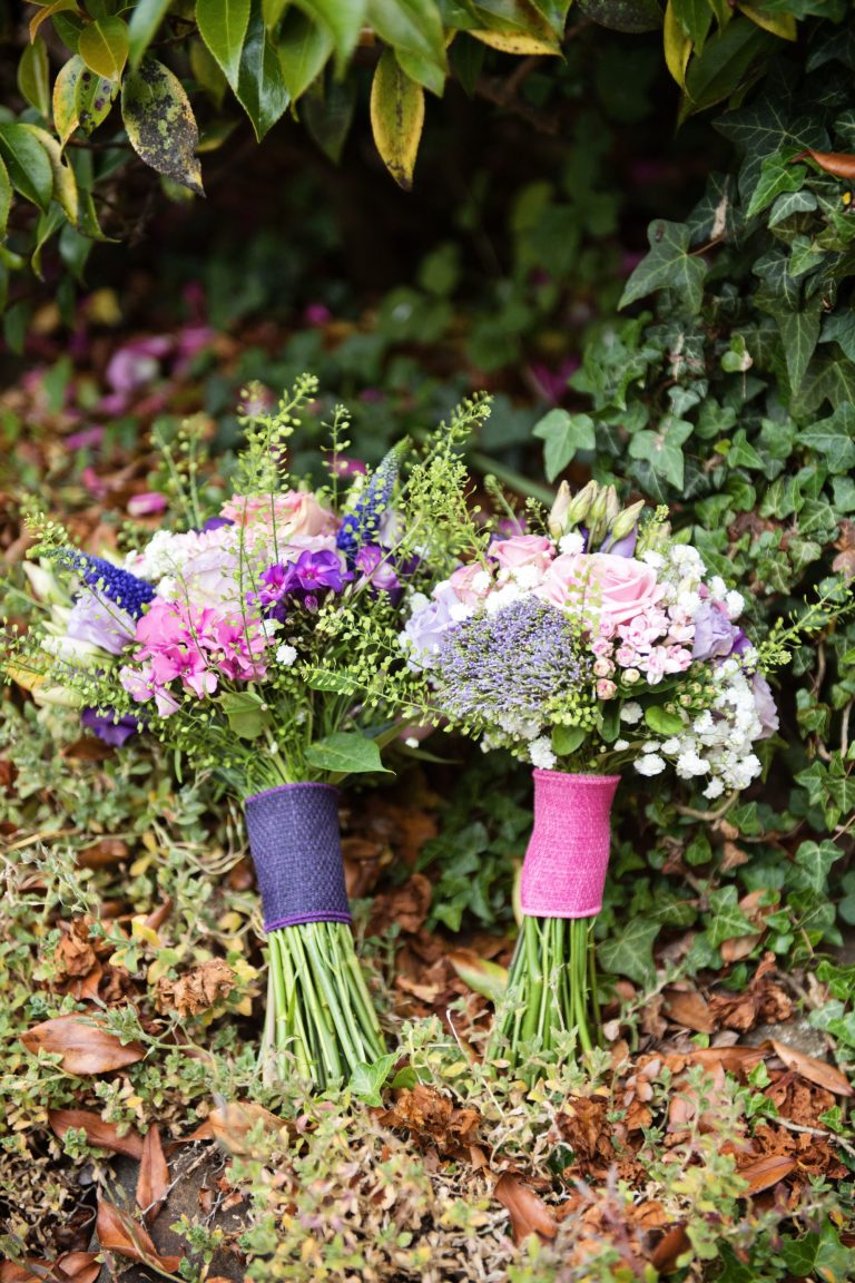 Wedding bouquets lying on some ivy.