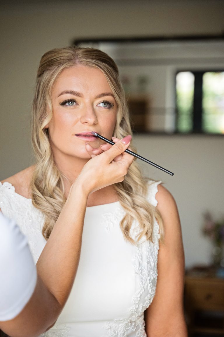 a bride having her lipstick applied