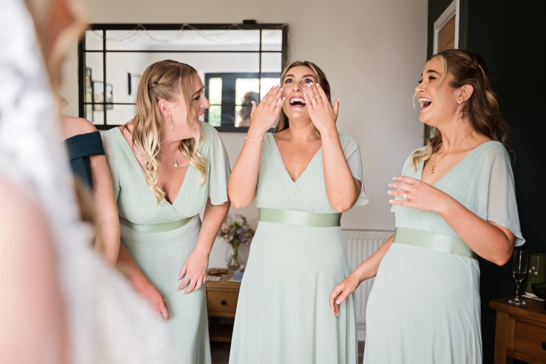 bridesmaids crying in emotion after seeing the bride for the first time.