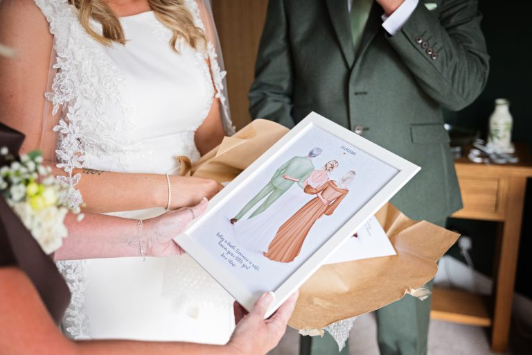 a lovely picture frame & picture of mother of the bride, father of the bride and bride standing together.