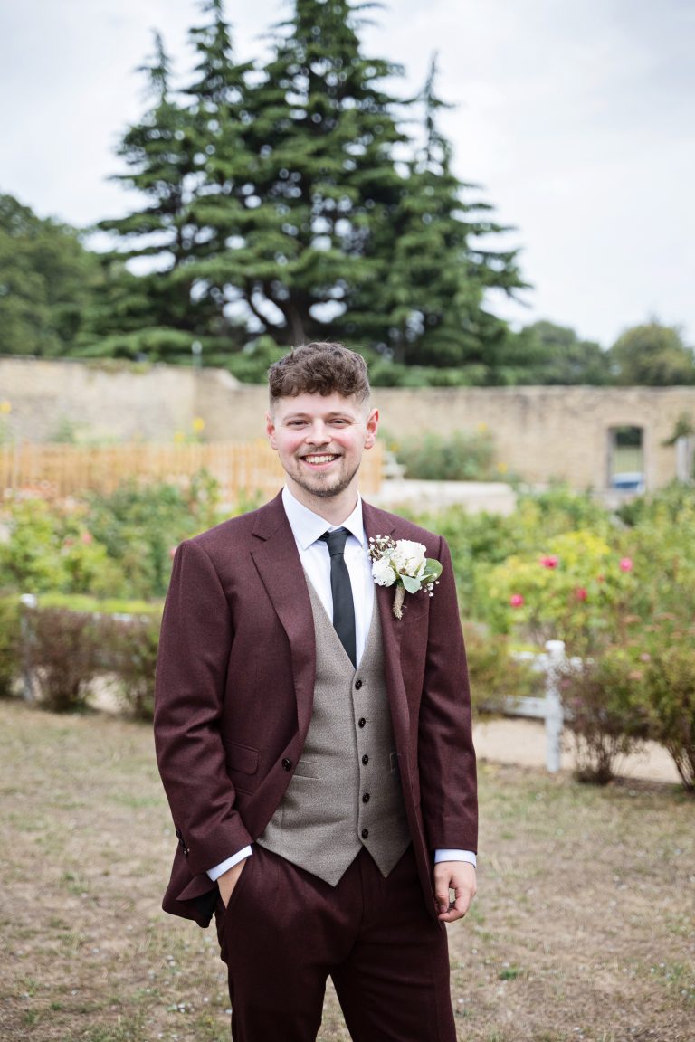 the groom standing with one hand in his pocket, smiling relaxed pre wedding