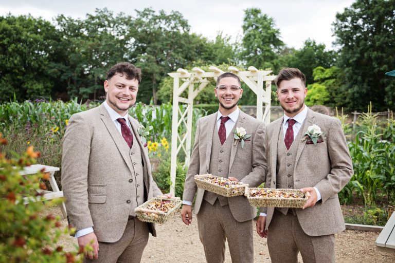 grooms men holding confetti