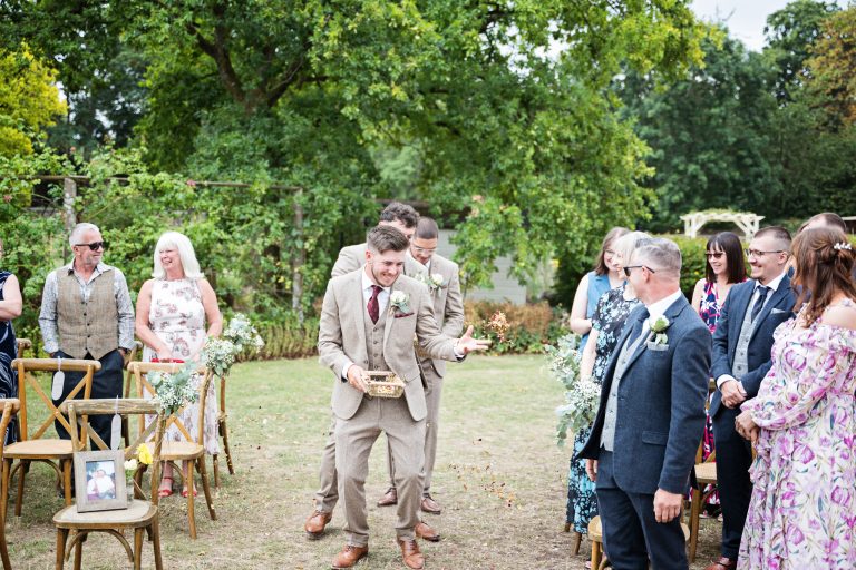 the ushers aka flower men, dance down the wedding isle throwing confetti at the wedding guests