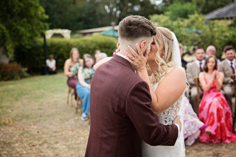 bride and groom kiss after being announced husband and wife