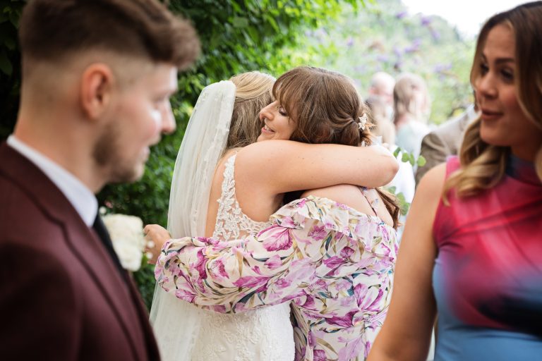 image of a bride being hugged by her new mother in law