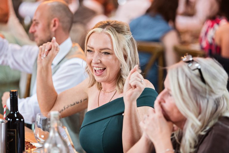 maid of honour laughing with her hands in the air