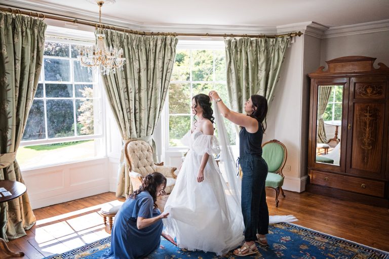 A bride having her veil put on her head. Set in a Georgian period looking bedroom