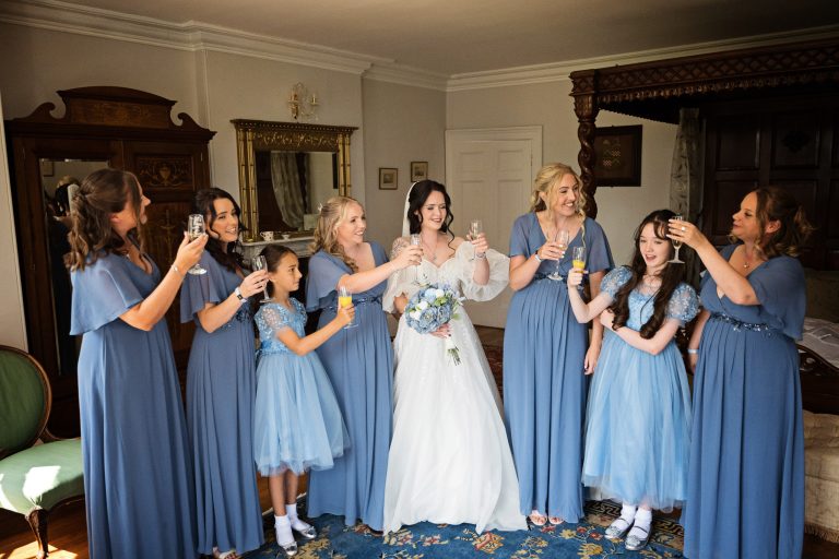 The bridal part raise a glass in celebration of getting ready on time