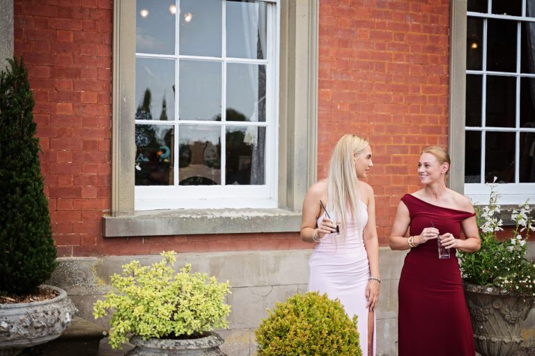 Relaxed wedding photographer homme house captures two guest candidly