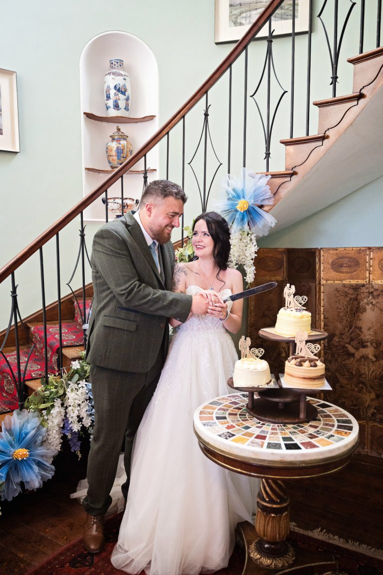 Candid photo of cutting the cake at Herefordshire wedding venue, Homme House.
