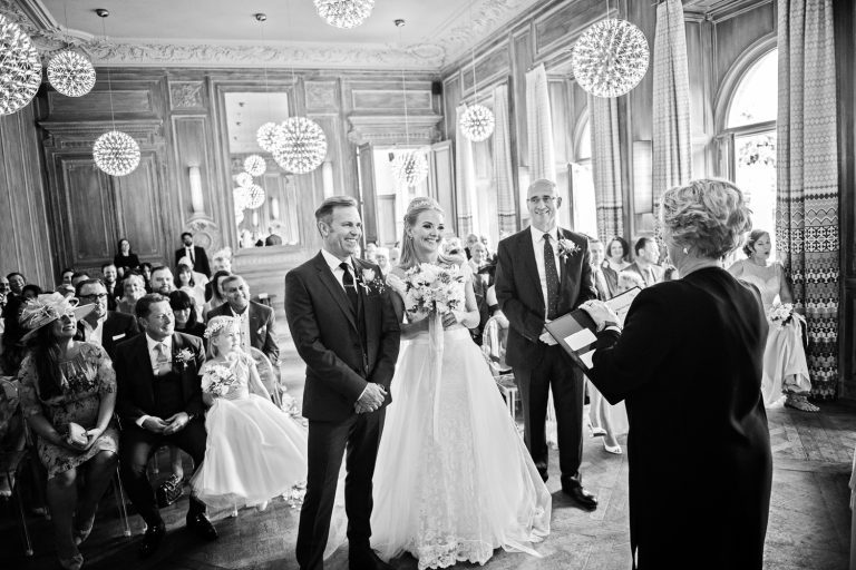 B&W image of a wedding ceremony taking place at Cowley Manor.