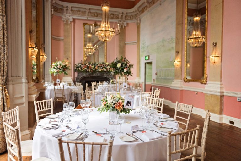 Wedding breakfast set up at Danesfield House. Chandeliers and ornate fixings make this look luxurious