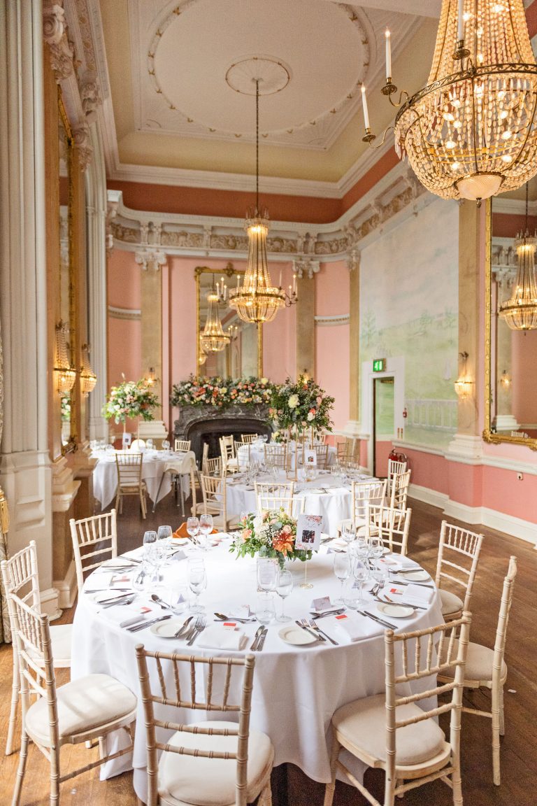 Wedding breakfast set up at Danesfield House. Chandeliers and ornate fixings make this look luxurious