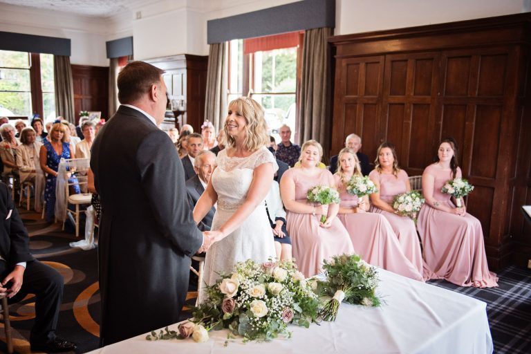Bride and groom getting married in front of their guests at the Double Tree Hilton, Cheltenham.