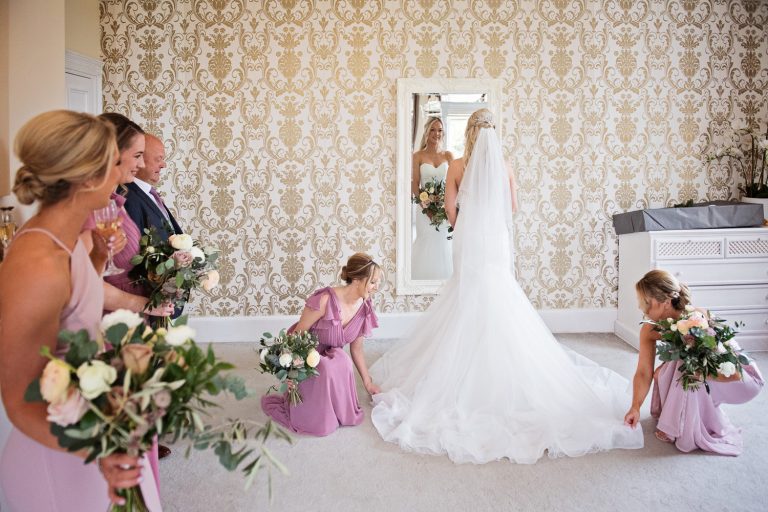 Bridesmaids laying out the brides dress.