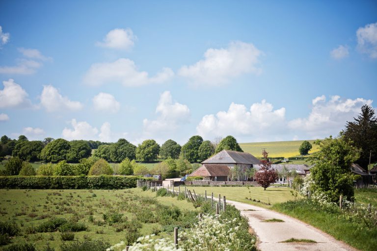 A gorgeous landscape photograph of the grounds at Farbridge, taken in May with lovely blue sky.