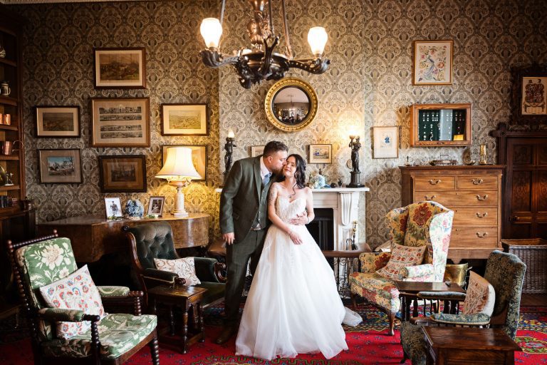 Bride and groom in the library of Homme House.