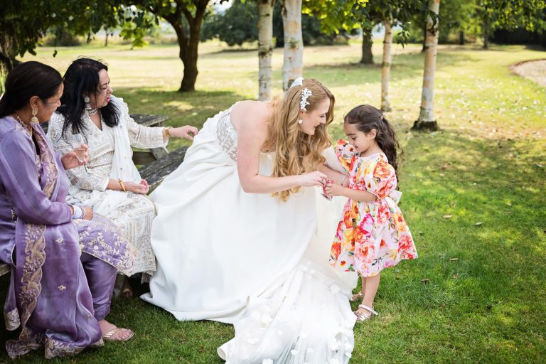 The bride chats to a little girl. Cute.
