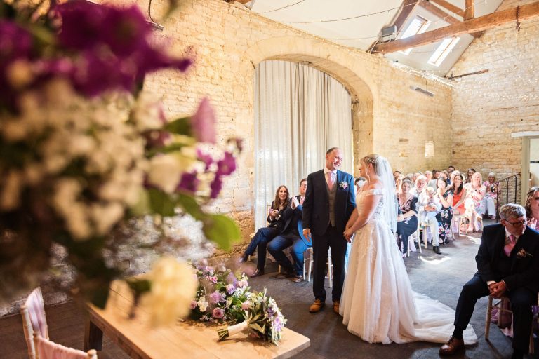 Bride and groom say their I do's at the Cotswold wedding venue, Lapstone Barn.