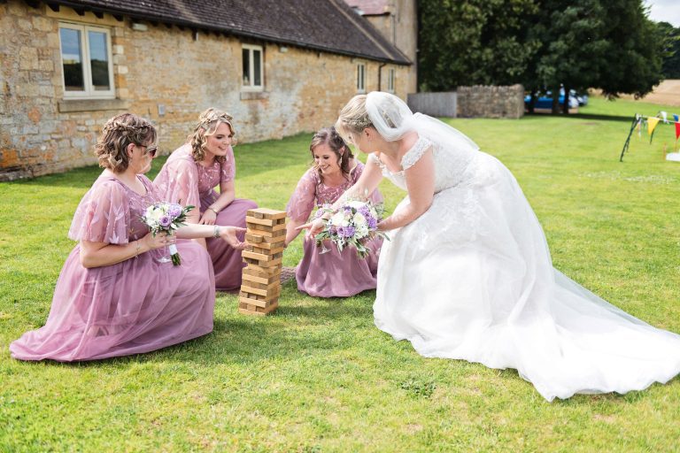 Team bride take a moment out to play a bit of Jenga!