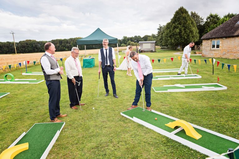 Fun photo of wedding guests playing pitch and put golf.