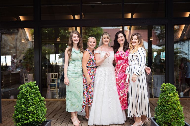 Relaxed formal photo of the bride and her friends.