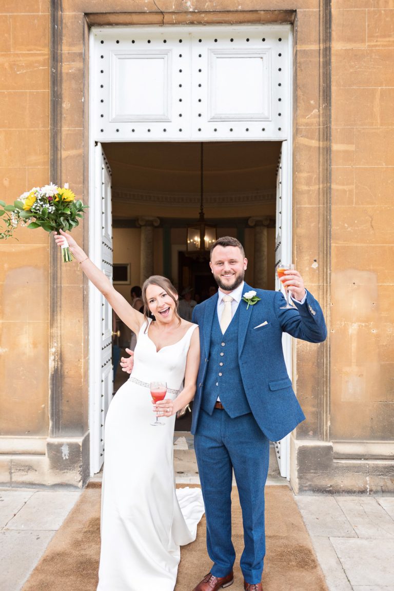 Portrait photo of bride and groom as they exit Leigh Court after getting married.