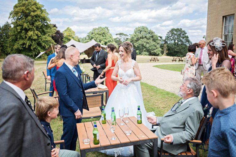 Candid photo of a bride chatting to her wedding guests.