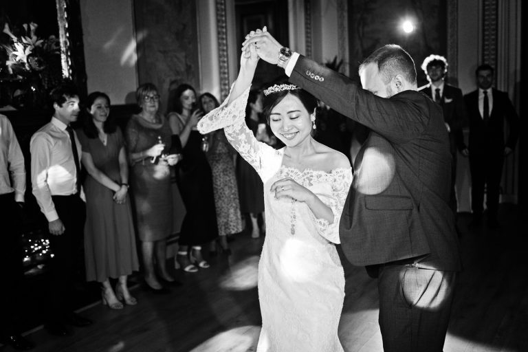 B&W photo of bride and groom doing their first dance.