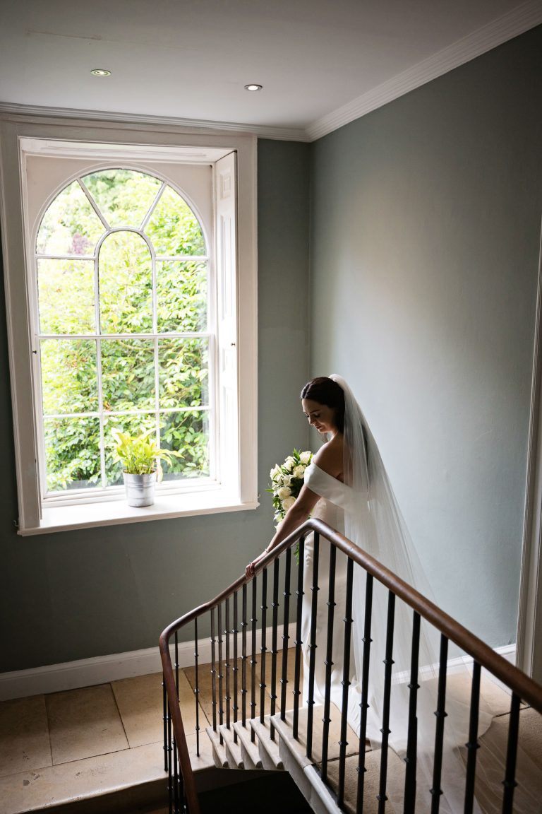 Stunning portrait photo of the bride walking down the stairs at the Matara.