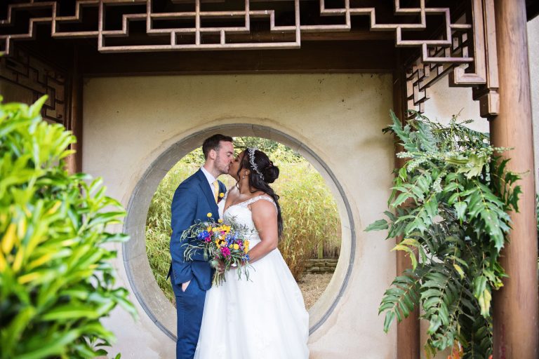 Bride and groom kiss underneath the famous circled archway at Matara.