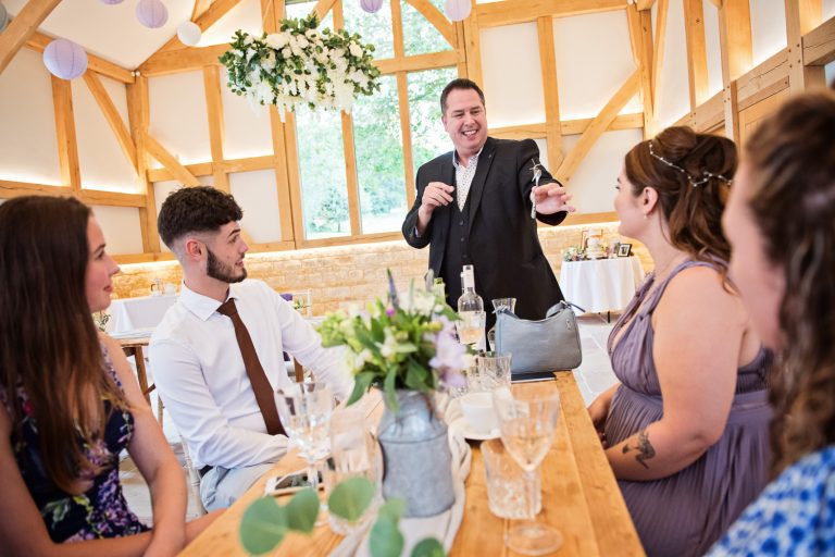 Gloucestershire Magician, Richard Parsons bending a fork, somehow to the amazement of wedding guests.