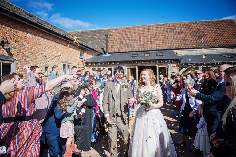 Confetti shot with bride and groom smiling.