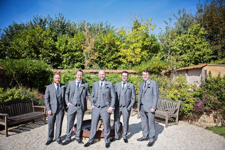 Groomsmen pose for a pic in the gardens.