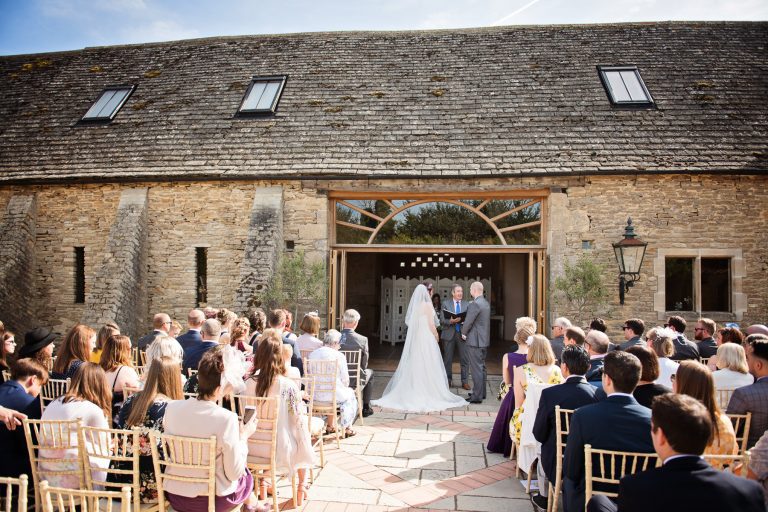 Outdoor wedding ceremony at Oxleaze Barn.