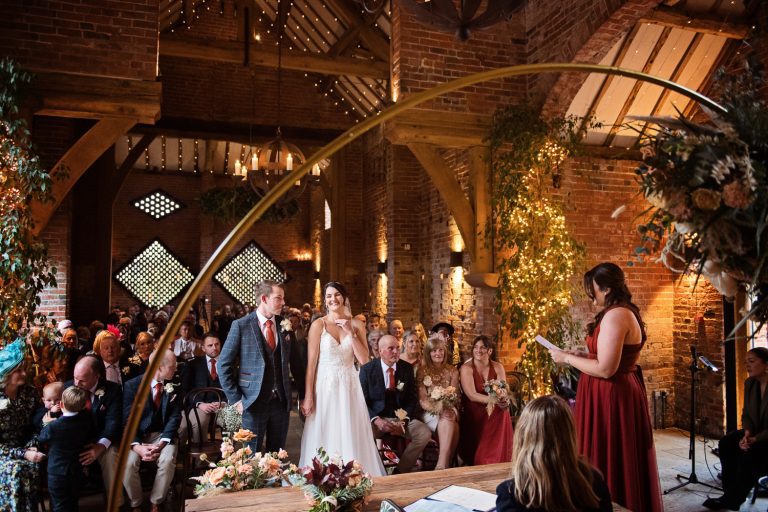 Bride and groom standing together during their wedding ceremony at Shustoke Barn