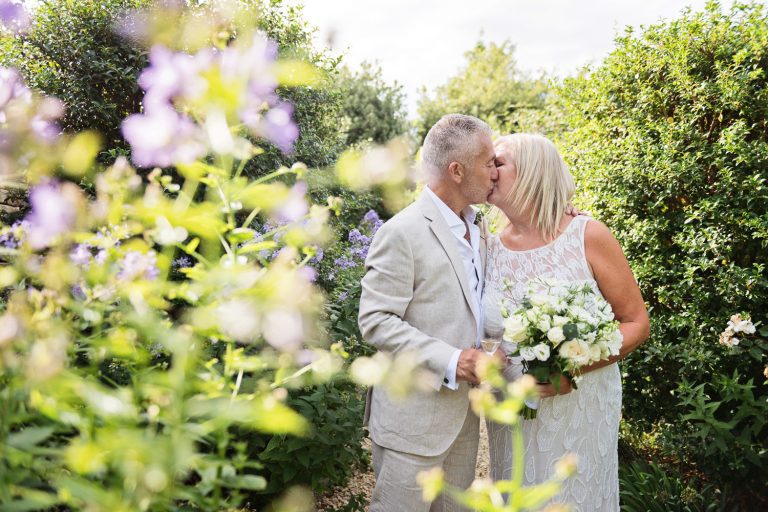 Bride and groom share a kiss.