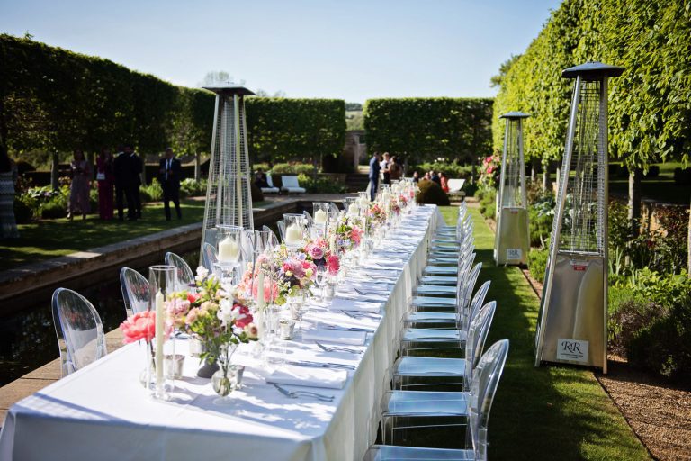 Outdoor wedding breakfast table set up in a garden.