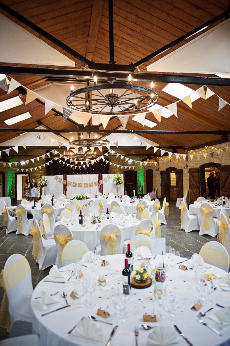 Portrait photograph of the barn set up for a wedding breakfast at The Barn at Berkeley.