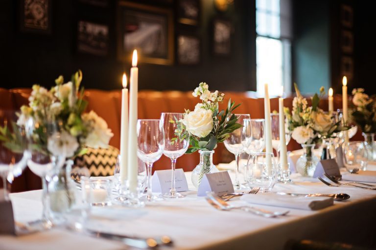 Wedding breakfast set up. Candles lit and flowers.
