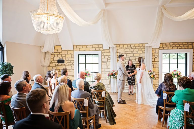 Bride and groom during their wedding ceremony at The Pear Tree, Purton.