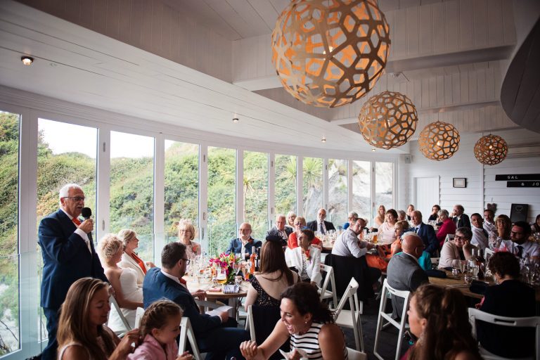Father of the bride delivers his wedding speech to the wedding guests at Tunnel Beach.