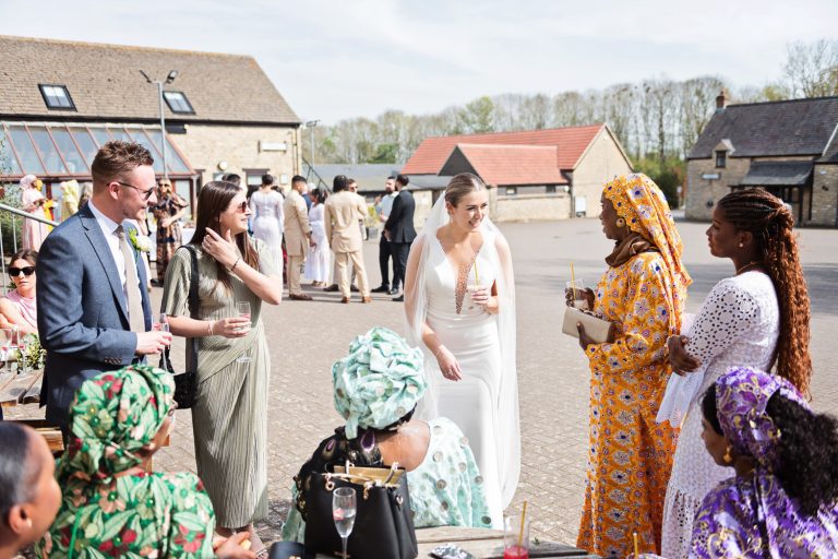 Bride chatting to wedding guests.