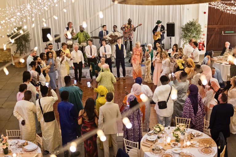 Overview of a wedding party in full swing at Worton Hall.