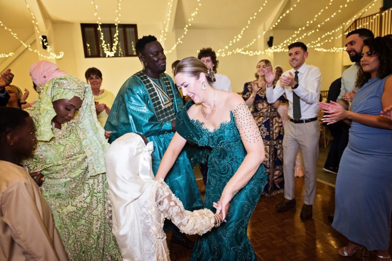 Bride dances with a young guest on her wedding day.