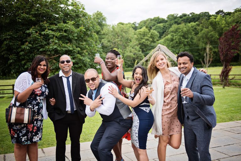 Friends at a wedding posing for the camera.