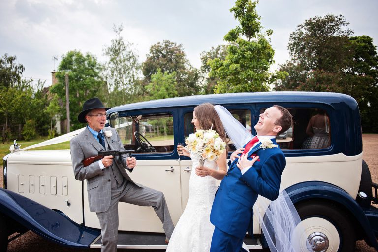 Fun pic of bride and groom getting shot by a gangster 1920's American style.