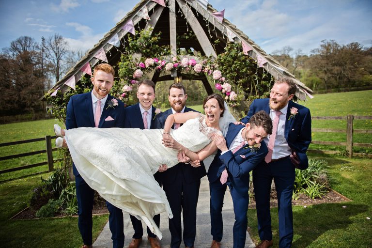 Groomsmen carry (just) the bride.